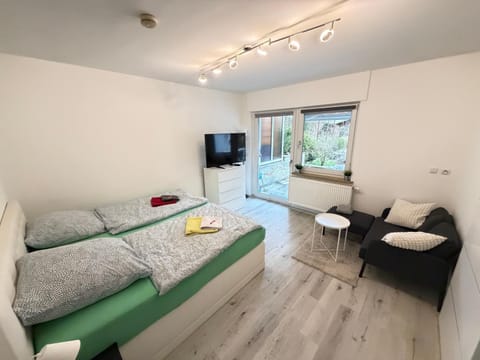 Bed, TV and multimedia, Living room, Seating area, Bedroom