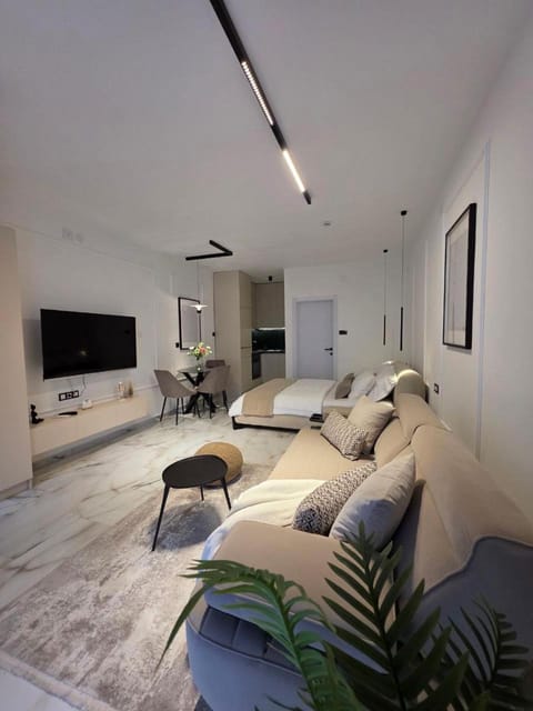 Bed, TV and multimedia, Living room, Seating area, Bedroom