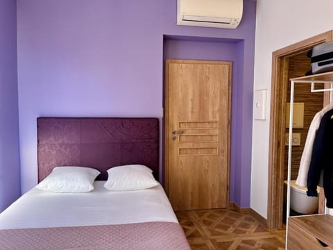 Bed, towels, wardrobe, air conditioner