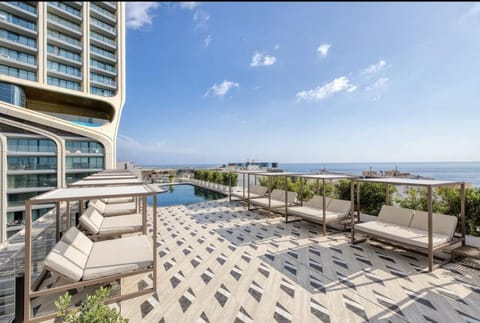 Property building, Patio, Day, Natural landscape, View (from property/room), Balcony/Terrace, Living room, Seating area, Pool view, Sea view, Swimming pool, sunbed