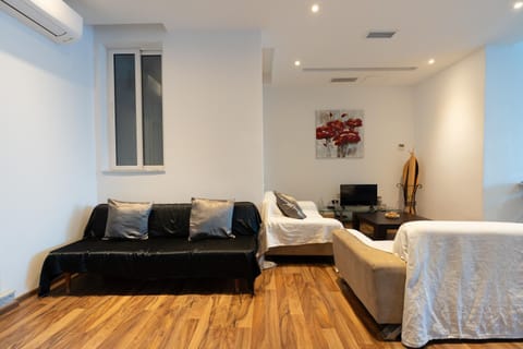 Bed, TV and multimedia, Living room, Seating area, air conditioner