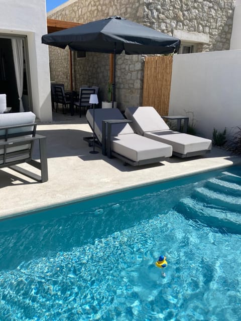 Patio, Day, Seating area, Pool view, Swimming pool, sunbed