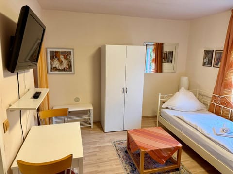 Bed, TV and multimedia, Living room, Seating area, wardrobe