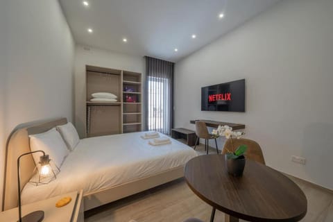 Bed, TV and multimedia, Seating area, Bedroom, towels, wardrobe