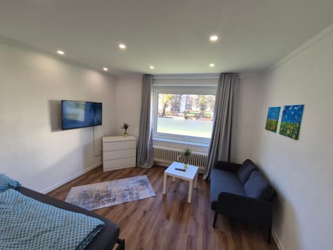 Bed, TV and multimedia, Living room, Seating area, Bedroom