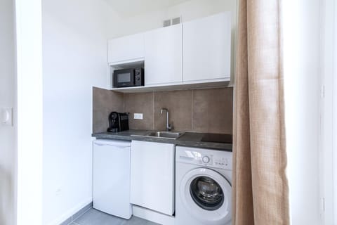 Kitchen or kitchenette, microwave, stove, washing machine