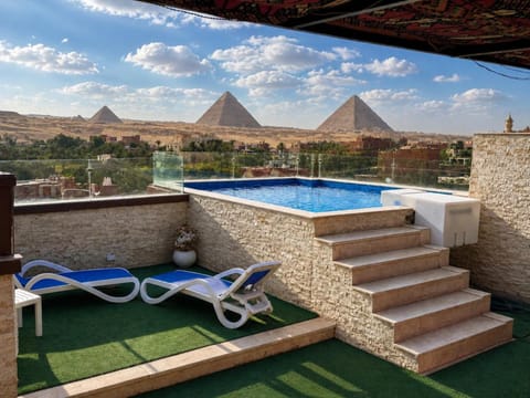 Property building, Patio, Nearby landmark, Day, Natural landscape, View (from property/room), Balcony/Terrace, Mountain view, Pool view, Swimming pool, sunbed