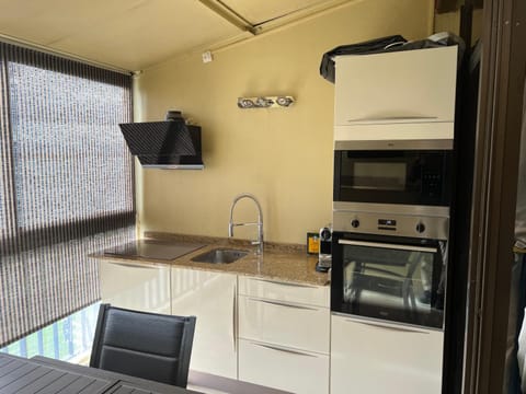 Kitchen or kitchenette, dishwasher, oven, stove