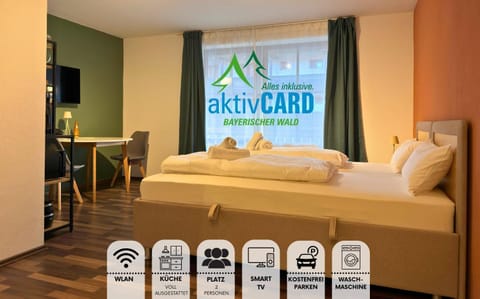 Bed, Property logo or sign, Activities, TV and multimedia, Photo of the whole room, Dining area, Bedroom, Text overlay, Time of day, Certificate/Award