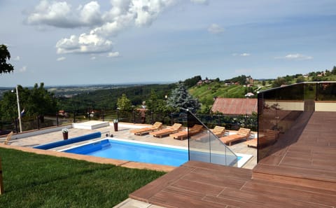 Property building, Patio, Day, Natural landscape, Pool view, Swimming pool, sunbed