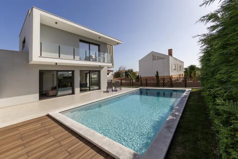 Property building, Patio, Pool view, Swimming pool, sunbed