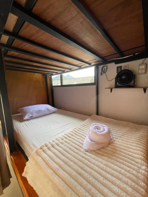 Bed, View (from property/room), Balcony/Terrace, Photo of the whole room, Text overlay, Mountain view, bunk bed, air conditioner