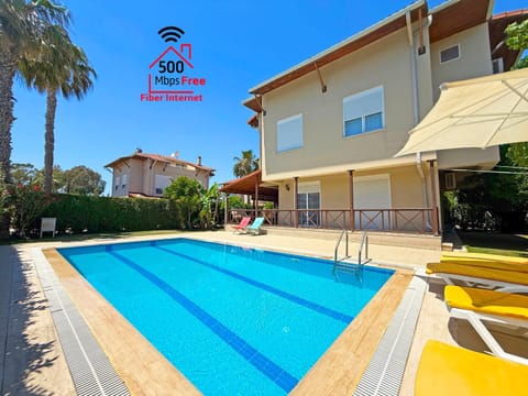 Property building, Day, Text overlay, Pool view, Swimming pool, sunbed