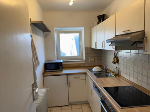 Kitchen or kitchenette, dishwasher, microwave, oven, stove