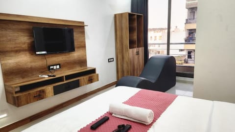 Bed, TV and multimedia, Seating area, Bedroom, towels, wardrobe