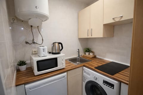 Kitchen or kitchenette, microwave, stove, toaster, washing machine