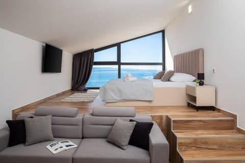 Bed, Natural landscape, TV and multimedia, Seating area, Bedroom, Sea view