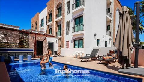 Property building, People, People, Property logo or sign, Lounge or bar, Pool view, Area and facilities, Swimming pool