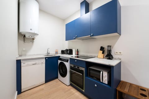 Kitchen or kitchenette, dishwasher, oven, stove, toaster, washing machine