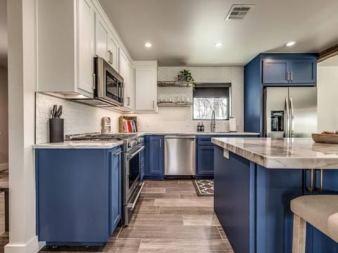 Kitchen or kitchenette, dishwasher, oven, stove