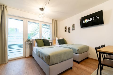 Bed, TV and multimedia, Living room, Seating area, Bedroom