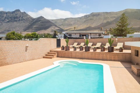 Property building, Patio, Nearby landmark, Day, Natural landscape, Lake view, Mountain view, Pool view, Swimming pool, sunbed