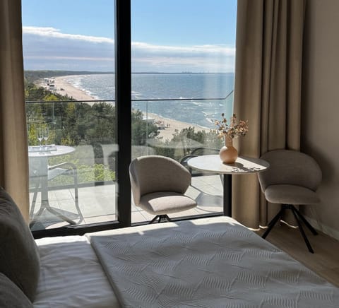 Nearby landmark, Bed, Natural landscape, Activities, View (from property/room), Balcony/Terrace, Living room, Photo of the whole room, Seating area, Beach, Bedroom, Landmark view, Sea view, Seasons, Time of day, Location