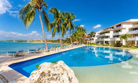 Property building, Nearby landmark, Day, Natural landscape, Beach, Pool view, Sea view, Swimming pool, sunbed