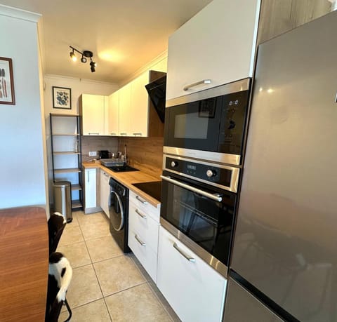 Kitchen or kitchenette, dishwasher, microwave, oven, stove