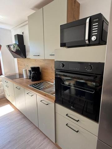 Kitchen or kitchenette, dishwasher, oven, stove, toaster