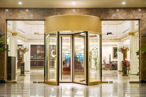 Property building, Facade/entrance, Property logo or sign, Lobby or reception, Lobby or reception, Seating area, furniture, elevator