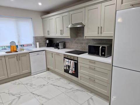 Kitchen or kitchenette, furniture, minibar, oven, stove, towels