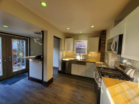 Kitchen or kitchenette, dishwasher, oven, stove
