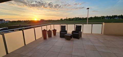 View (from property/room), Balcony/Terrace, Seating area, Sunset