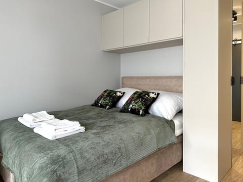 Bed, towels, wardrobe
