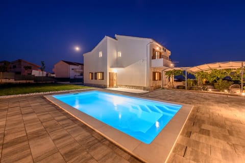 Property building, Patio, Night, Pool view, Swimming pool