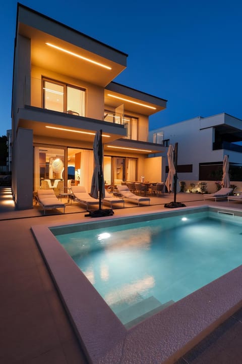 Property building, Patio, Night, Swimming pool, sunbed