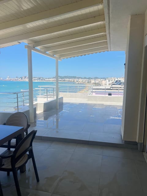 Patio, Day, View (from property/room), Balcony/Terrace, Living room, Seating area, Dining area, Beach, Sea view
