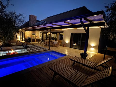 Property building, Patio, Night, Pool view, Swimming pool, sunbed