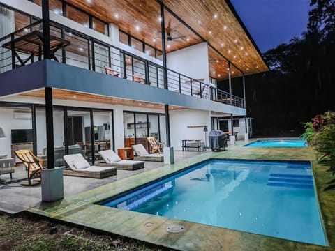 Property building, Patio, Night, Natural landscape, Seating area, Pool view, Swimming pool, sunbed