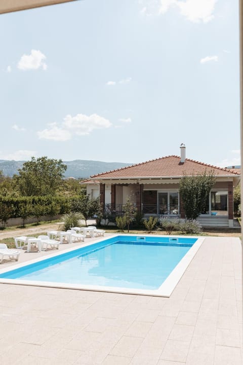Property building, Day, Natural landscape, Pool view, Swimming pool, Swimming pool, sunbed