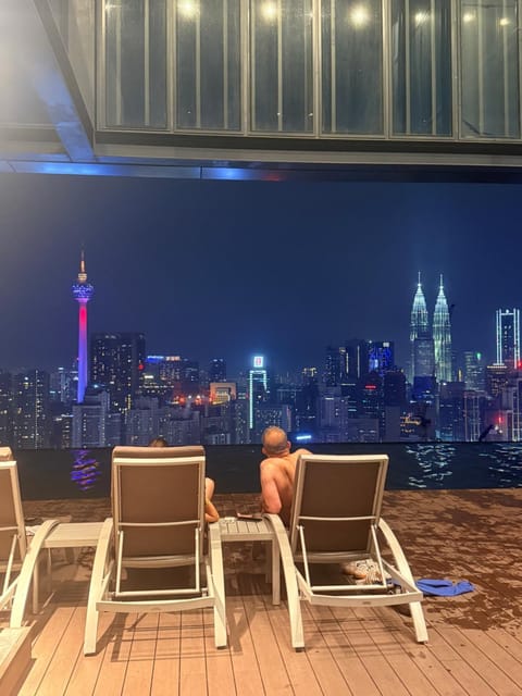 Night, View (from property/room), Seating area, City view, Swimming pool