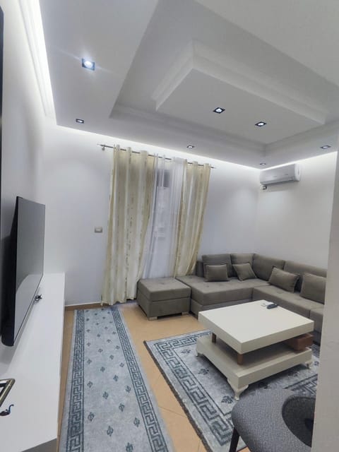 Bed, TV and multimedia, Living room, Seating area, air conditioner