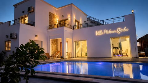 Property building, Patio, Night, Pool view, Swimming pool, Swimming pool, sunbed