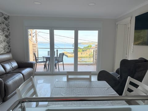 Property building, Natural landscape, View (from property/room), Balcony/Terrace, Living room, Seating area, Dining area, River view, Sea view