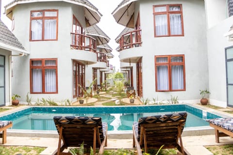 Property building, Patio, Day, View (from property/room), Balcony/Terrace, Balcony/Terrace, Living room, Seating area, Pool view, Swimming pool, sunbed