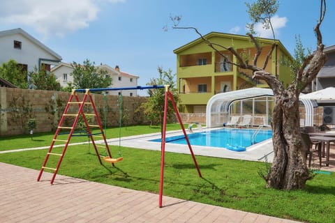 Property building, Facade/entrance, Day, People, Natural landscape, Summer, BBQ facilities, Children play ground, Garden, View (from property/room), Balcony/Terrace, On site, Garden view, Pool view, Area and facilities, Area and facilities, Swimming pool, Swimming pool, Sports, Entertainment, Seasons, Time of day, children, young children, Family