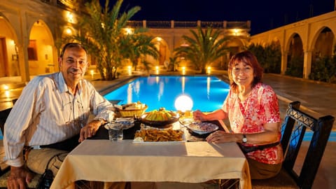 Patio, Night, Dining area, Food, Guests, Pool view, Swimming pool, Dinner, Drinks, group of guests