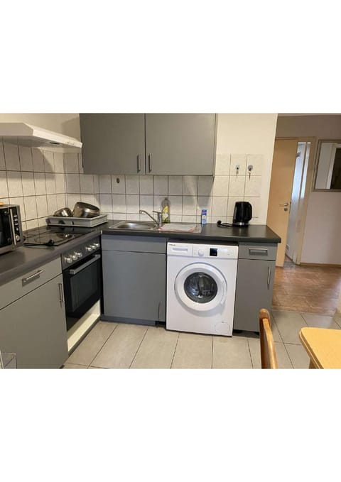 Kitchen or kitchenette, oven, stove, washing machine, dryer