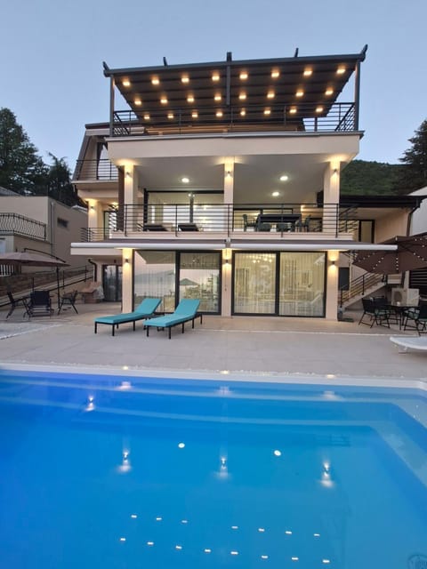 Property building, Patio, Pool view, Swimming pool, sunbed